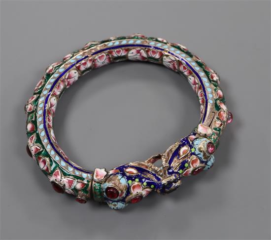 An Indian enamelled and foil backed paste? set white metal bangle.